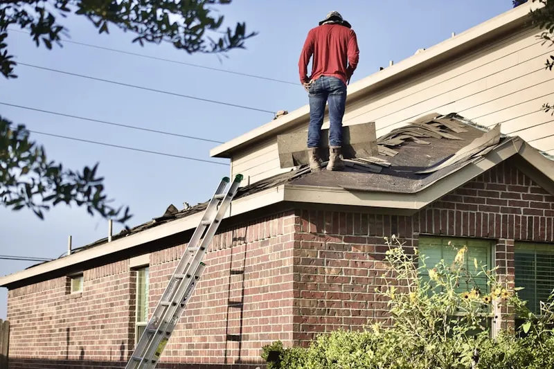 Professional roofer working on a residential roof in The Core